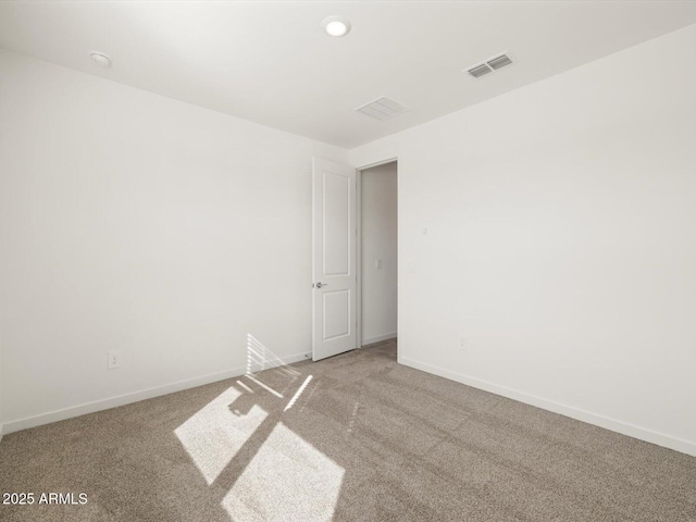 spare room featuring recessed lighting, baseboards, visible vents, and carpet