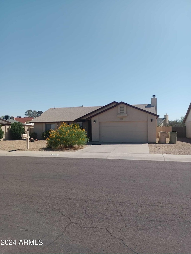 ranch-style house featuring a garage