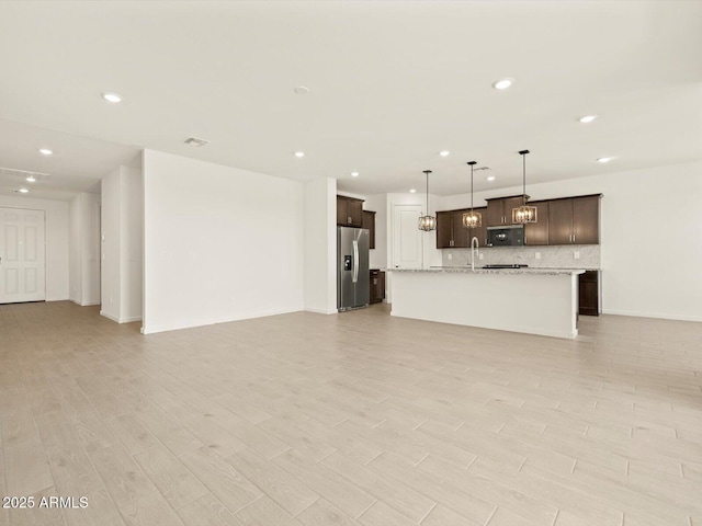 4035 S 176th Dr, Goodyear, AZ 85338 - unfurnished living room featuring recessed lighting and light wood-style flooring