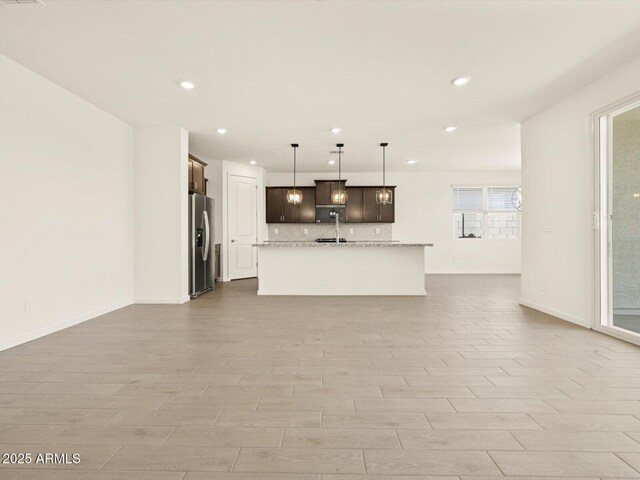4035 S 176th Dr, Goodyear, AZ 85338 - unfurnished living room with recessed lighting and light wood-style floors