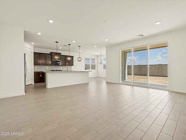 4035 S 176th Dr, Goodyear, AZ 85338 - unfurnished living room featuring recessed lighting and light wood-style floors