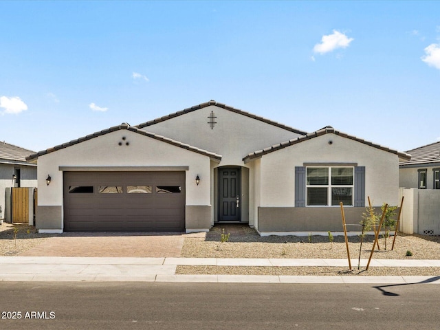 4035 S 176th Dr, Goodyear, AZ 85338 - mediterranean / spanish home with decorative driveway, a tile roof, an attached garage, and stucco siding
