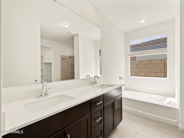 4035 S 176th Dr, Goodyear, AZ 85338 - full bath with a garden tub, double vanity, and wood finished floors