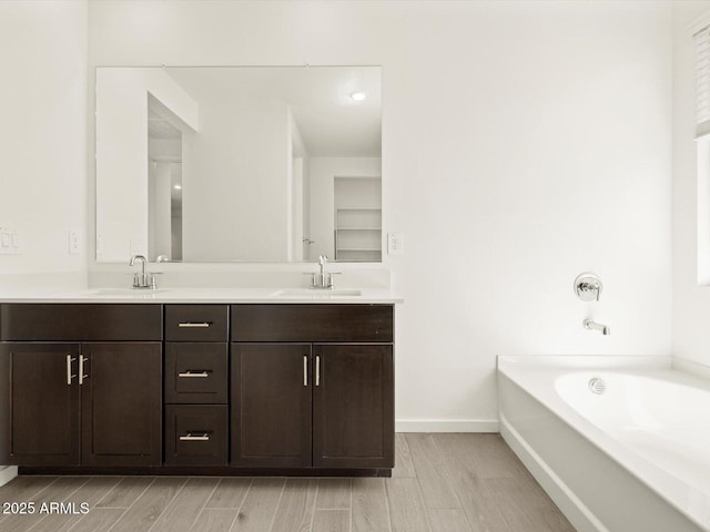 4035 S 176th Dr, Goodyear, AZ 85338 - bathroom with double vanity, a bath, and wood tiled floors