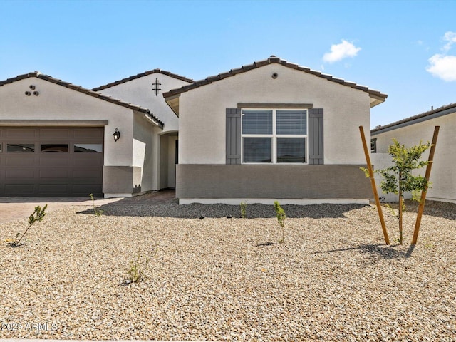 4035 S 176th Dr, Goodyear, AZ 85338 - mediterranean / spanish-style home featuring a garage, stucco siding, a tile roof, and driveway