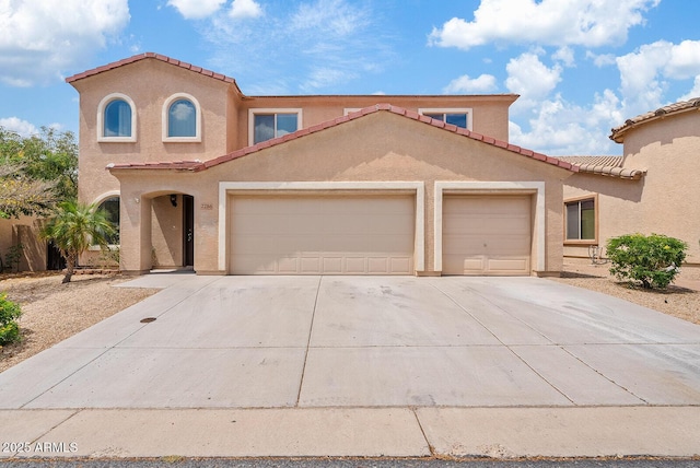 2286 E Mohave Ln, Apache Junction, AZ 85119 - mediterranean / spanish-style house with a garage, concrete driveway, a tiled roof, and stucco siding