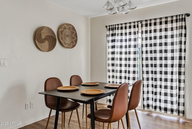 2286 E Mohave Ln, Apache Junction, AZ 85119 - dining space featuring a chandelier, wood finished floors, and baseboards