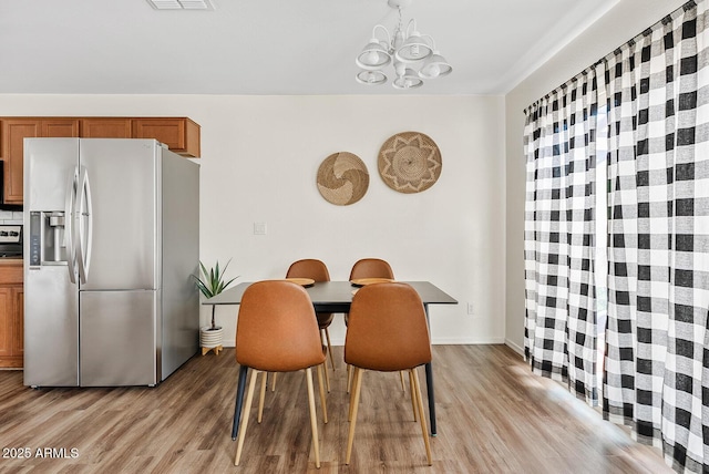 2286 E Mohave Ln, Apache Junction, AZ 85119 - dining space with a chandelier, light wood-style floors, and baseboards