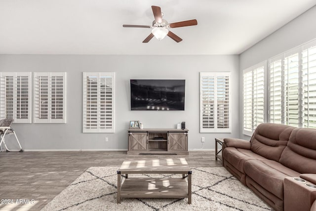 living room featuring wood-type flooring and ceiling fan