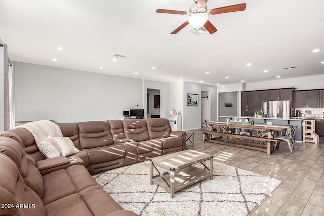 living room featuring ceiling fan and light hardwood / wood-style flooring