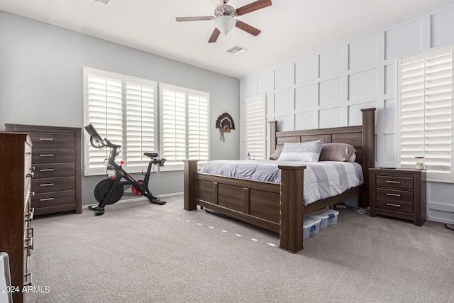 bedroom featuring light carpet and ceiling fan