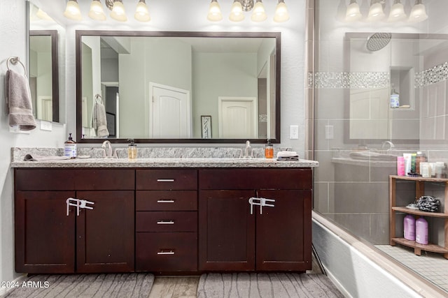 bathroom with enclosed tub / shower combo and vanity