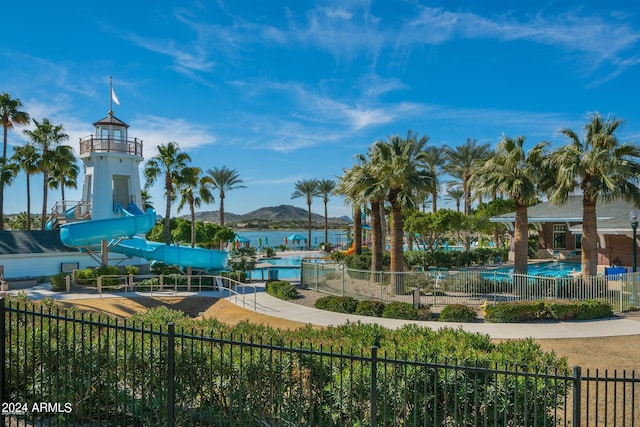 view of property's community featuring a swimming pool and a water and mountain view