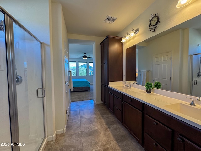 bathroom with a shower with door and vanity