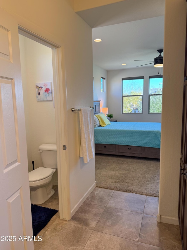 bathroom featuring toilet and ceiling fan