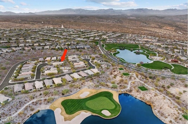 birds eye view of property with a water and mountain view