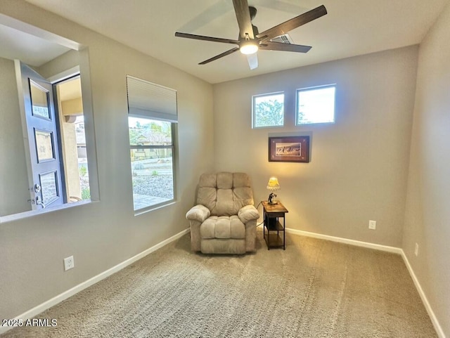 sitting room with ceiling fan and carpet floors