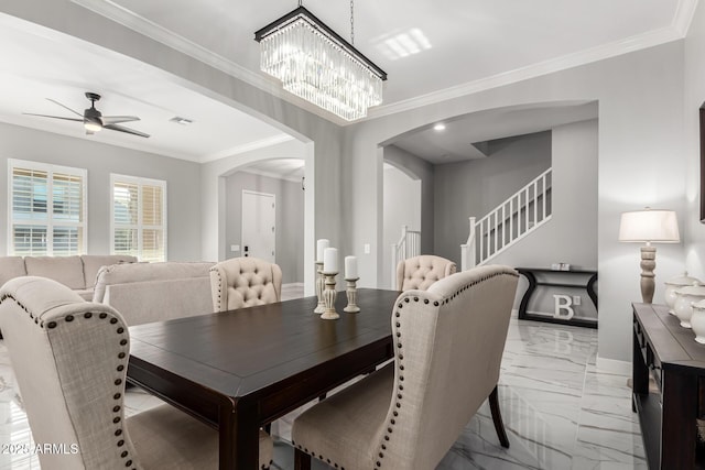 dining space with crown molding and ceiling fan with notable chandelier