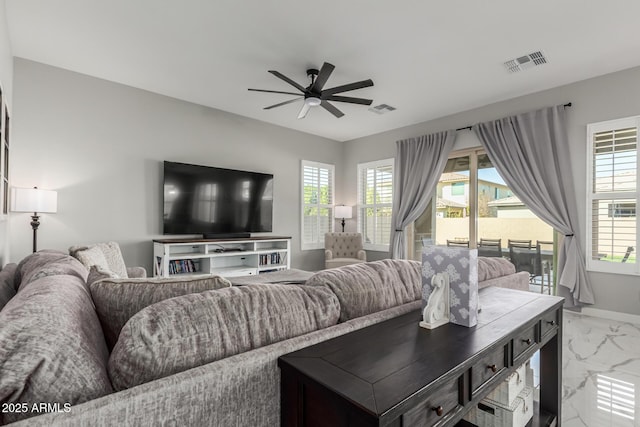 living room with ceiling fan and plenty of natural light