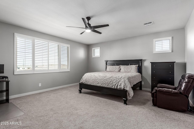 carpeted bedroom with ceiling fan and multiple windows