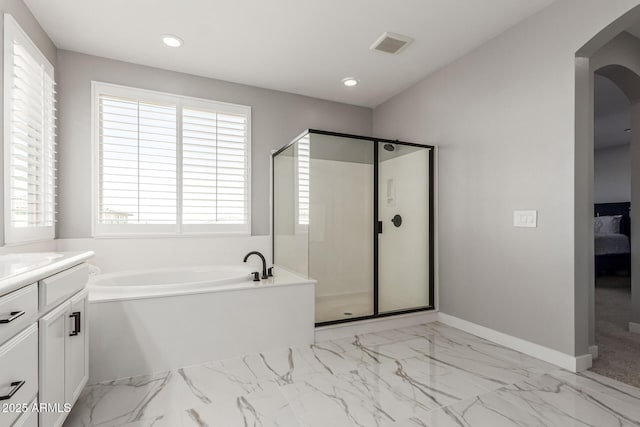 bathroom with vanity and independent shower and bath