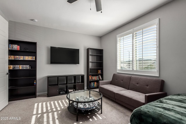 carpeted living room with ceiling fan