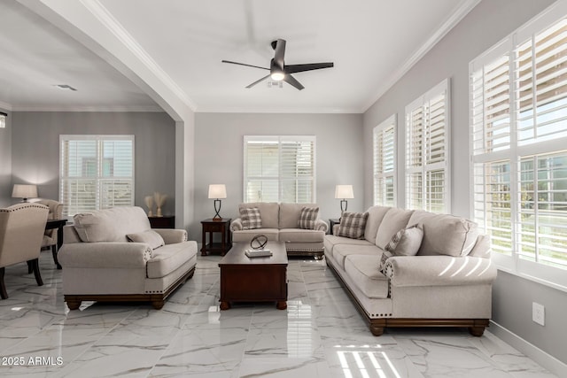 living room with ceiling fan and ornamental molding