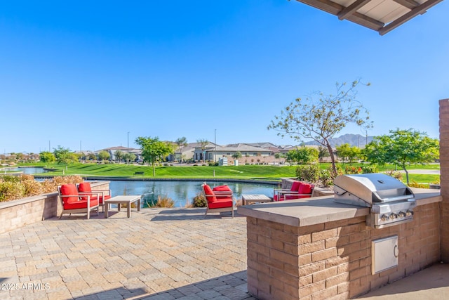 view of patio / terrace with a water view, grilling area, and area for grilling