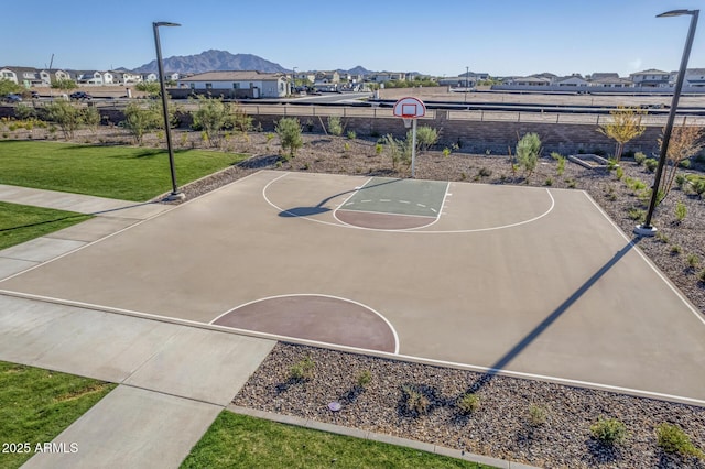 view of sport court with a lawn and a mountain view