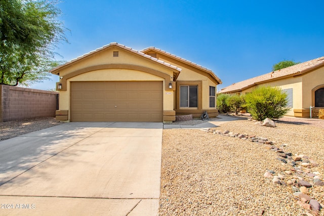 ranch-style home featuring a garage