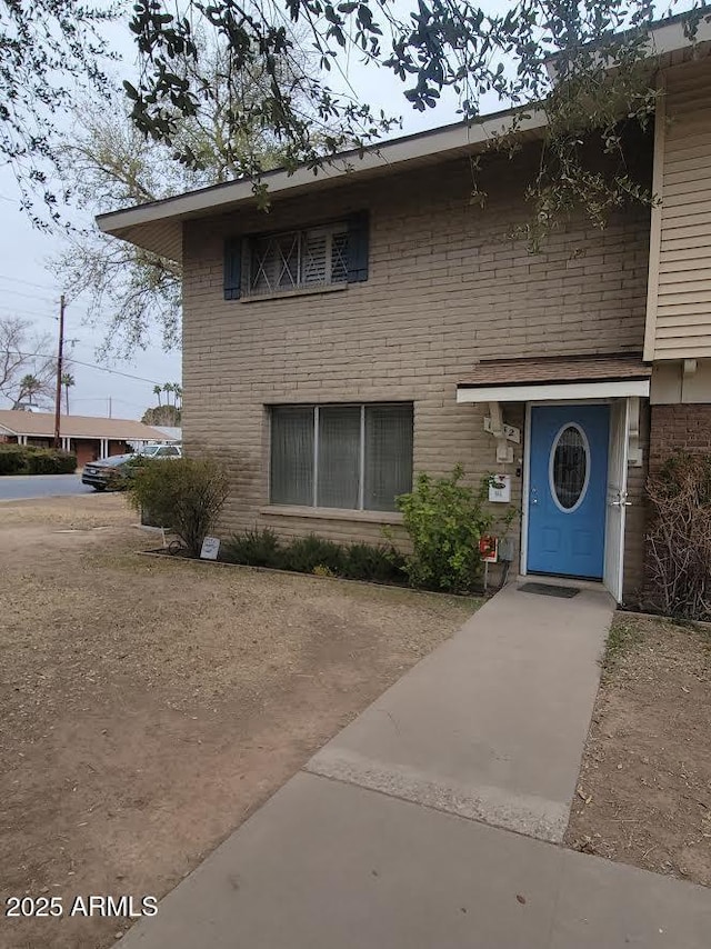 view of front of home featuring brick siding