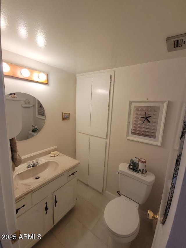 bathroom featuring toilet, vanity, tile patterned flooring, and visible vents