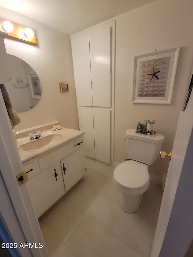 bathroom with vanity, tile patterned flooring, and toilet