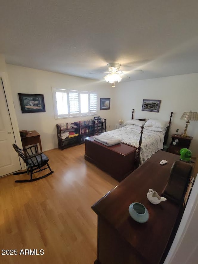 bedroom with light wood-style flooring and ceiling fan