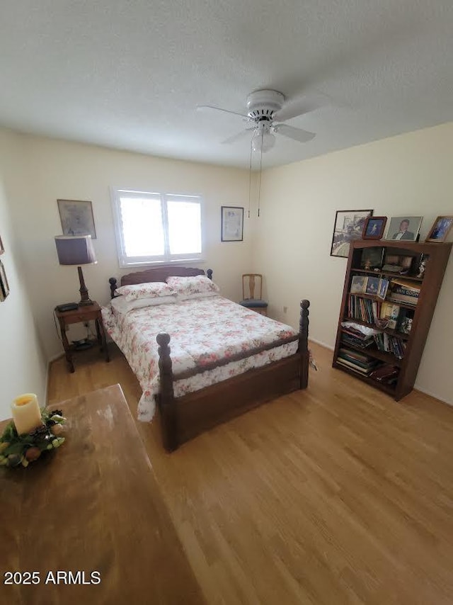 bedroom featuring light wood-type flooring and ceiling fan