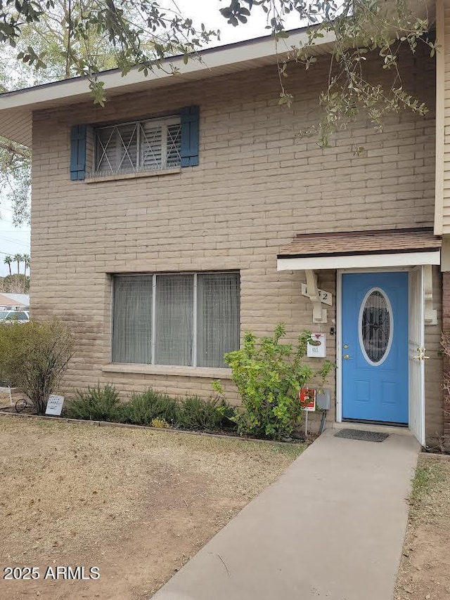 view of front of house featuring brick siding