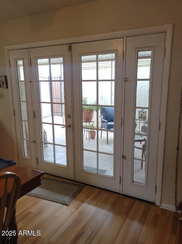 entryway with light wood-style flooring and french doors