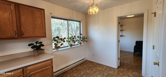 corridor with dark parquet flooring, a baseboard heating unit, and an inviting chandelier