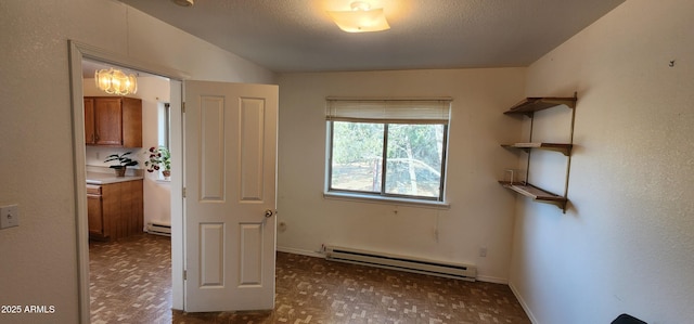 unfurnished bedroom with a baseboard radiator and a textured ceiling