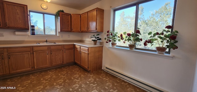 kitchen with sink, light parquet flooring, and baseboard heating