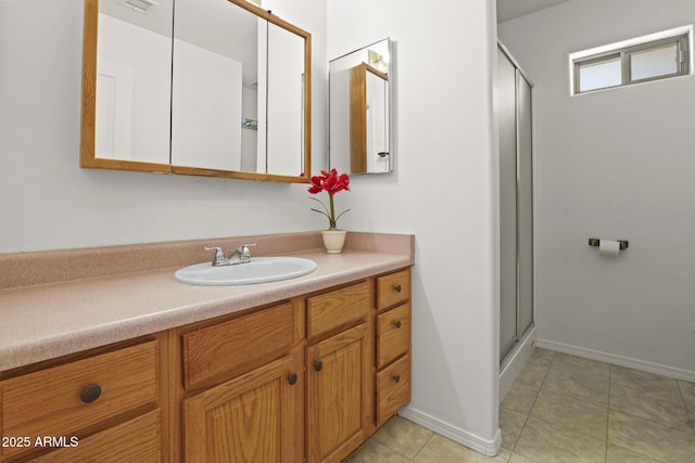 bathroom featuring vanity, an enclosed shower, and tile patterned flooring