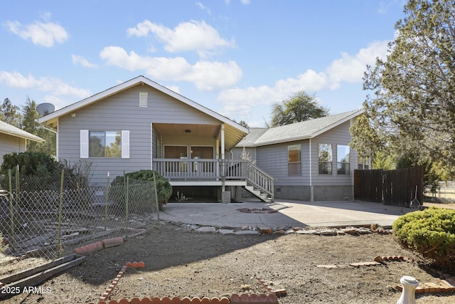 rear view of property with a porch and a patio