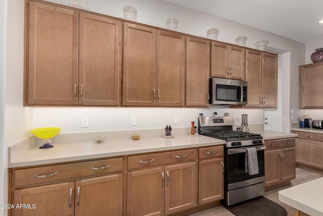 kitchen featuring stainless steel appliances and light hardwood / wood-style floors