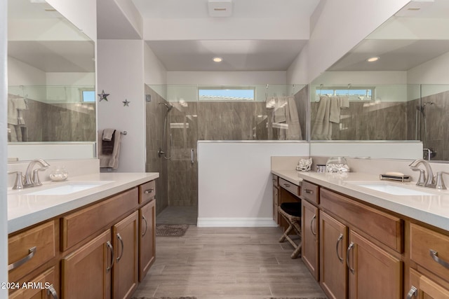 bathroom featuring hardwood / wood-style floors, vanity, and a shower with door