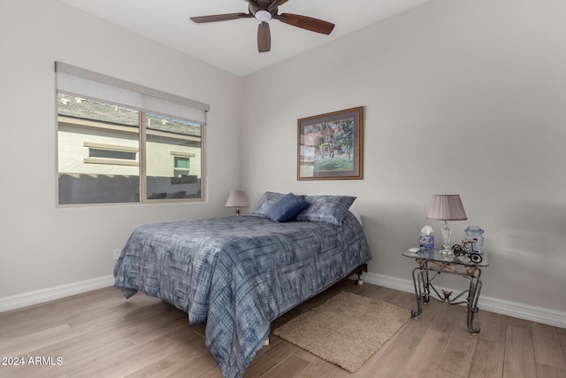 bedroom with ceiling fan and light hardwood / wood-style flooring