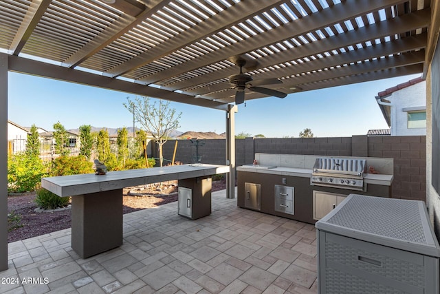 view of patio / terrace featuring a pergola, exterior kitchen, and grilling area