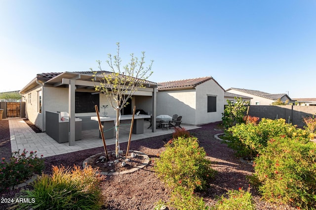 rear view of house with a patio