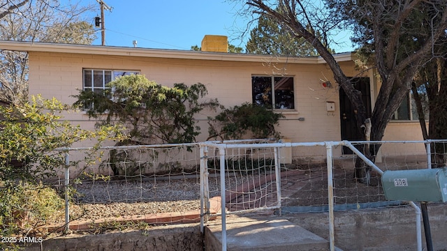 view of front of property featuring a chimney and fence