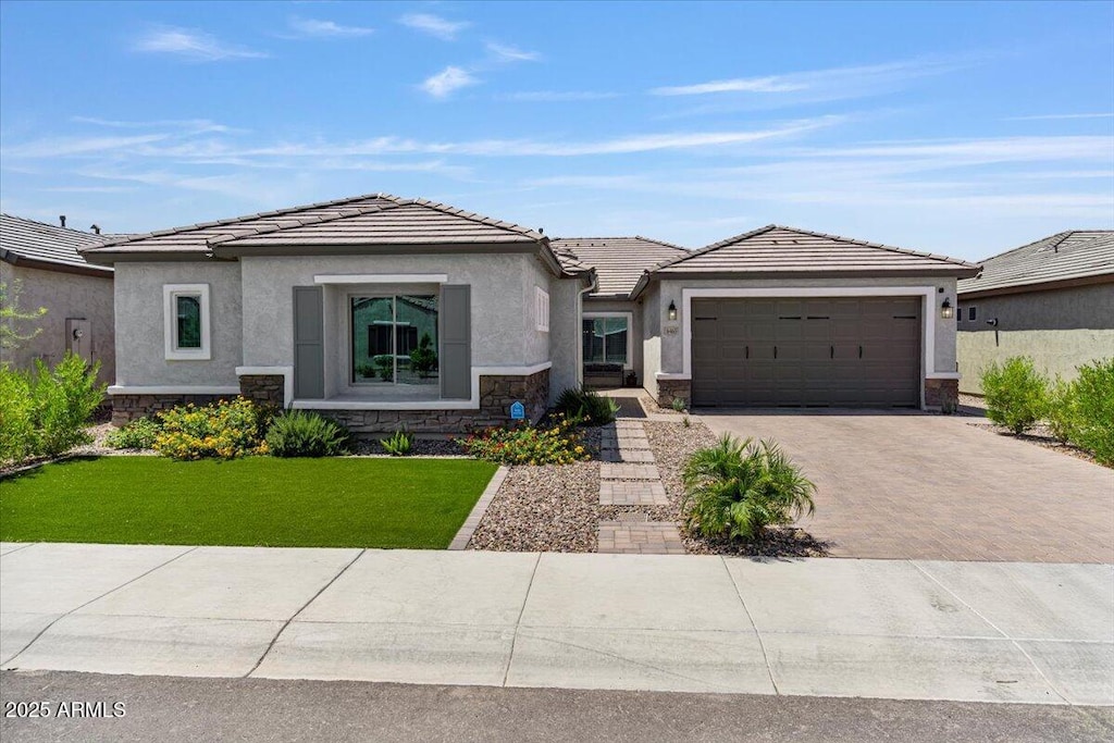 view of front of house with a garage and a front yard