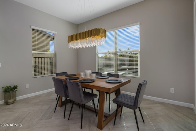 dining space with a notable chandelier and light parquet flooring